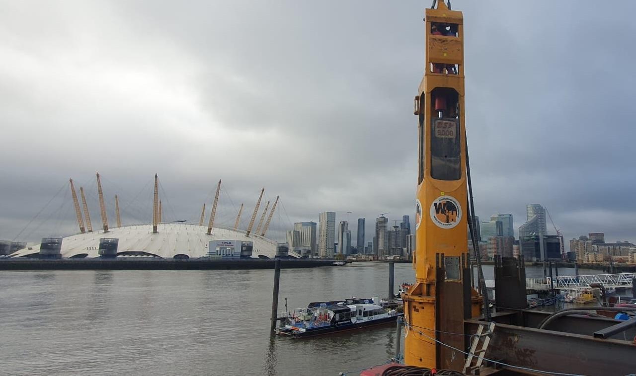 Image showing Watson & Hillhouse crane suspended vibrator and power pack installing tube and sheet piles to create a cofferdam and pier for the new Govan Partick Bridge over the River Clyde